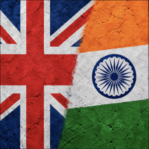 UK and Indian flags painted on a textured concrete surfac
